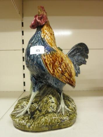 A French pottery cockerel shaped spill holder decorated with