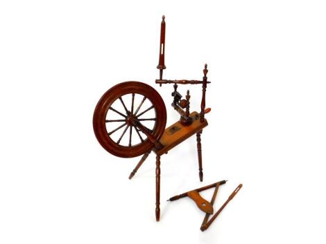 A 19thC oak and beech spinning wheel, 112.5cm high, 78cm wide.