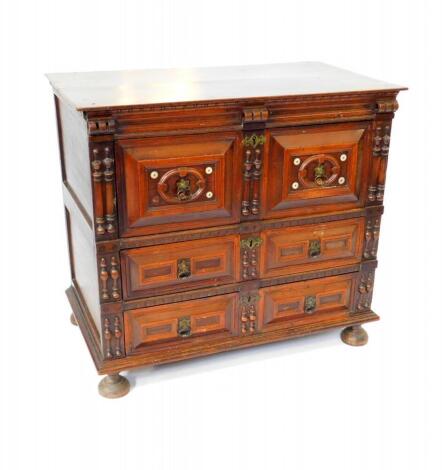 A Continental 17thC and later oak and walnut chest, of two short over two long drawers, raised on bun feet, 88cm high, 97cm wide, 56cm deep.