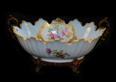 A Limoges porcelain bowl, brass mounted, of oval twin handled form, painted with reserves of flowers, against a turquoise ground, gilt heightened, printed mark, paper label for A F Rosignoli, Pionbino, 32cm wide.