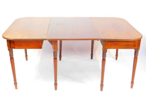 A George III mahogany D-end dining table, with one additional leaf, raised on turned legs, 70cm high, 106cm wide, 170cm deep.