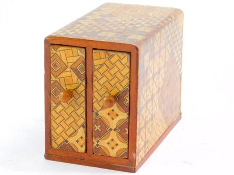 A Japanese early 20thC marquetry inlaid box, with two drawers, 8.5cm high, 6cm wide, 10.5cm deep.