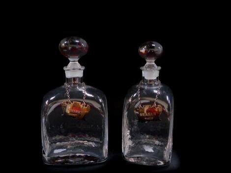 Two Dartington Crystal decanters, with plain globular stoppers, and silver brandy and whisky labels, Sheffield 1977.