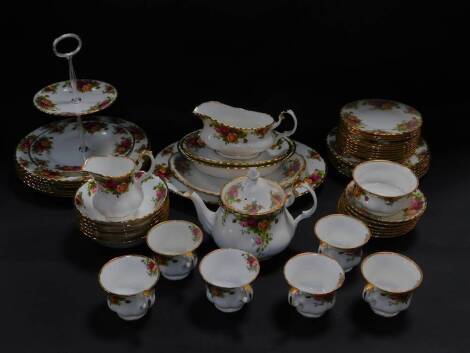 A Royal Albert porcelain tea service, decorated in the Old Country Roses pattern, comprising bread plate, tea pot, cream jug and sugar bowl, two tier cake stand, six cups and saucers and tea plates, together with a part dinner service, comprising meat pla