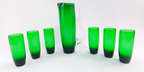 An emerald green mid 20thC glass lemonade set, possibly Scandinavian, the jug with a clear glass handle, comprising jug, 28cm high., and six tumblers. (7)