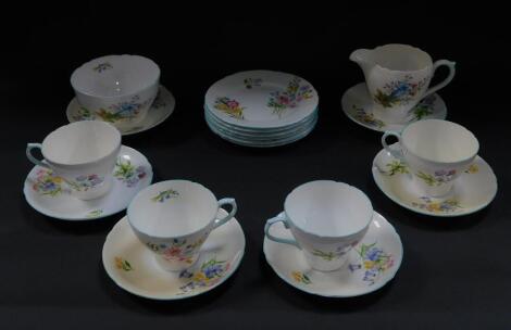 A Shelley porcelain part tea service decorated in the Wild Flowers pattern, comprising cream jug, sugar bowl, four cups, six saucers and tea plates.