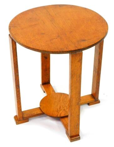 An Art Deco oak circular occasional table, raised on square supports united by an X frame base with circular under tier, 50.5cm high, 43.5cm diameter.