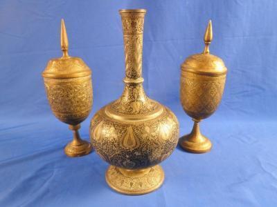 A late 19th/early 20thC Indian white metal bottle shaped vase decorated