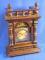 A German walnut mantel clock with an arched brass dial and silvered chapter ring