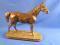 After P J Mene. A bronzed resin figure of a horse on a rectangular base with rounded ends