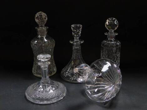 A cut glass mallet shaped decanter and stopper, cut glass whiskey decanter and stopper, Wedgwood cut glass whiskey decanter and stopper, and two further decanters. (5)