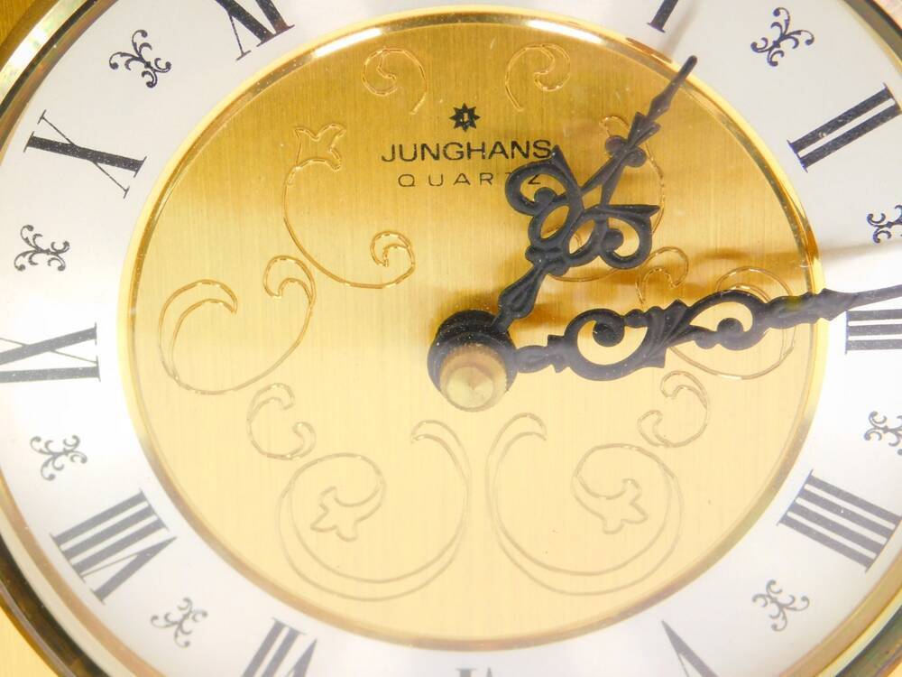 A Junghans brass cased carriage clock the circular dial with