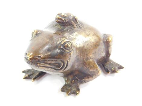 A Chinese 19thC metal figure of a toad, with a baby toad on its back, white metal on bronze, 9cm wide.