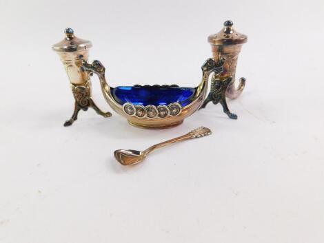 A pair of Norwegian silver salt and pepper pots, in the form of Viking horns, Theodore Olsen, Bergen and a Theodore Olsen salt cast as a long boat, with blue glass liner and spoon, 1.85oz.