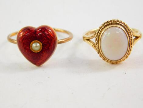 A seed pearl and red enamel heart shaped ring, on a yellow metal mount, size O, together with a 9ct gold and opal ring, size J/K, 4.8g.