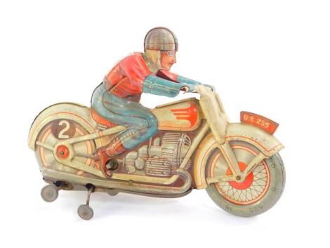 A German post WWII US Zone tin plate toy motorcycle and rider, clockwork movement, 18cm wide.