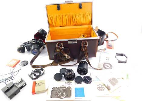 A Canon F-1 Montreal 1976 camera, with a 55mm spherical lens, serial number 286728, a 135mm zoom lens, serial number 90644, further lens, filters and instructions, cased.