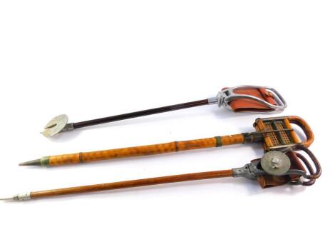 An early 20thC bamboo and cane French shooting stick, 88cm high, and two English shooting sticks, 82.5cm and 83cm high respectively. (3)