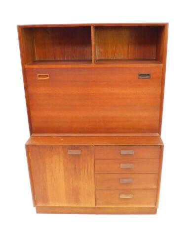 A G Plan style 1970's teak lounge cabinet, with two recesses above a fall flap, opening to reveal two staggered shelves, above a cupboard door flanked to the right by four drawers, raised on a plinth base, 91.5cm wide, 42cm deep, 136cm high.