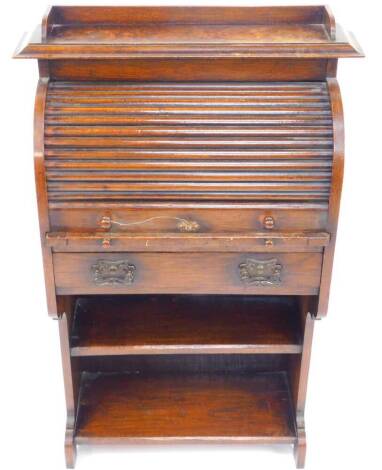 A Victorian oak student's cylinder bureau, the tambour front opening to reveal a drawer and recesses, above a slide and frieze drawer, over a two shelf bookcase, raised on shaped end supports, 74cm wide, 35cm, deep, 116cm high.