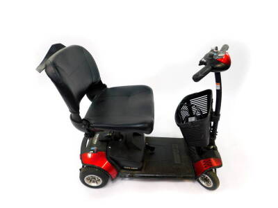 A Go-Go red mobility scooter, with battery and key.