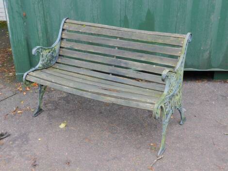 A Victorian style garden bench, with cast iron supports and slatted seat.