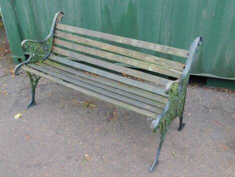 A Victorian style garden bench, with cast iron supports and slatted seat.