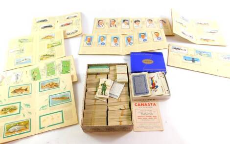 A collection of cigarette cards, including some in original albums by John Player, and many loose cards, playing cards, etc. (a quantity)