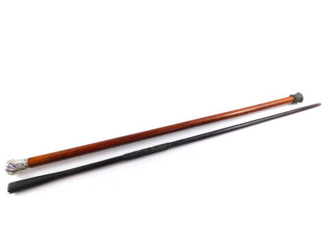 A Victorian tapered malacca walking cane, with whorl fluted silver knop with monogram, 89cm long., together with an African carved ebony tapered walking staff with metal tip, 95cm long. (2)