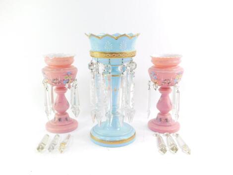 A late Victorian blue glass lustre vase, with hanging lustre drops and gilt painted decoration, 33.5cm high., and a pair of late Victorian pink glass lustre vases, 26cm high, (AF). (3)