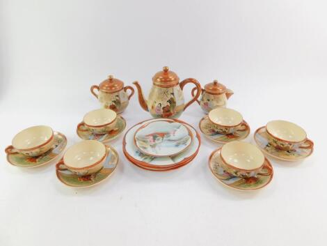 A Japanese earthenware coffee service, painted with figures on a terrace, together with porcelain plates and a saucer of similar design.