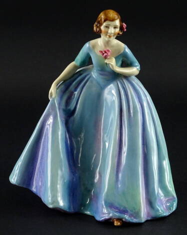 A Royal Worcester porcelain figurine The Duchess's Dress, modelled by Freda Doughty, the dress with a shaded purple, pink and turquoise glaze, printed marks in green and handwritten sculptors name to underside, 23cm high.