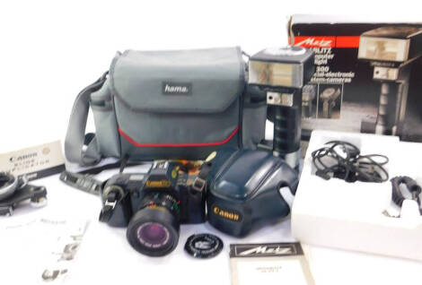 A Canon T70 camera, with a 35/70mm zoom lens, a Canon slide duplicator, no. 55, boxed and a Metz telecomputer quadrolight, with a special electronic system camera, 45CT-4, boxed. (3)