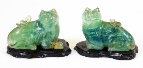 A pair of Chinese carved green quartz figures of felines, each on wood base, 19th/20thC, 8cm high.