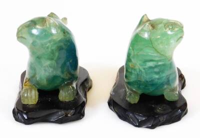 A pair of Chinese carved green quartz figures of felines, each on wood base, 19th/20thC, 8cm high. - 2