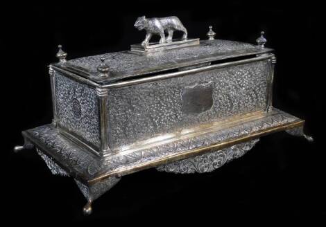 An early 20thC Indian ceremonial freedom casket, of rectangular form, with tiger knop, heavily repousse decorated with scrolls, with urns and a shield shaped plaque, presented to H.E. Sir Malcolm Hailey Kt K.C.S.I. CIE Governor Of The Punjab, by the Distr