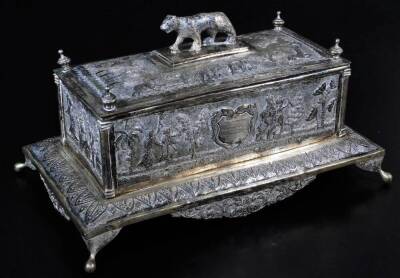 An early 20thC Indian ceremonial freedom casket, of rectangular form with tiger knop, urn finials and raised with various figures on elephants, trees and flowers, on a shaped base, with elongated orb feet and a shaped front apron repousse decorated with s