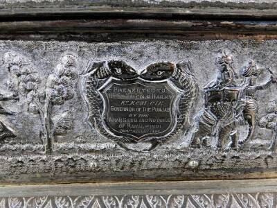 An early 20thC Indian ceremonial freedom casket, of rectangular form with tiger knop, urn finials and raised with various figures on elephants, trees and flowers, on a shaped base, with elongated orb feet and a shaped front apron repousse decorated with s - 7