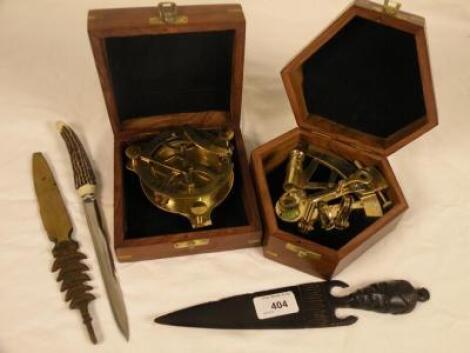 A modern replica brass sextant in a hardwood case