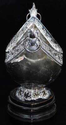 An early 20thC Indian ceremonial bowl, of shaped ellipse form with heavily cast ring handles, and a pierced border set with flowers, on an oval foot, filigree decorated with further flowers heads, on a removable wooden plinth base, 31cm high, 38cm wide. - 4