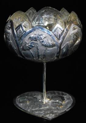 An early 20thC Indian pin cushion, of heart shaped form, with a repousse decorated banding, set with oversized figures, trees, and houses, with a material centre, a heart shaped dish and a shaped goblet on a heart shaped base, 12cm high, all Indian white - 4