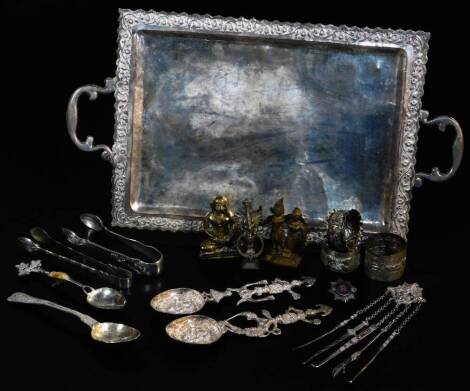 Various early 20thC Indian items, a tray of rectangular form with fixed handles, 40cm wide, various napkin rings, spoons, other metal ware etc., some Indian white metal, unmarked. (a quantity)