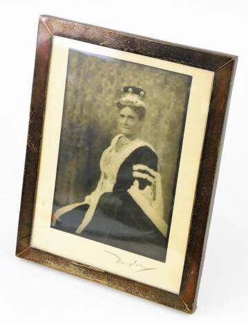 Douglas. A portrait photograph of Lady Allesandra Hailey, wife of Sir (later Lord) W M Hailey Governor Of The Punjab And The United Provenances India, contained in a plain photograph frame marked sterling silver, with an oak back and easel, signed to the 