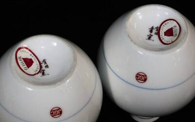 A pair of Japanese porcelain vases, each decorated with flowering shrubs on a white ground, marked JGC, similar cups, similar bowls, and a collection of other Oriental ceramics, blue and white tea bowls, etc. (a quantity) - 18