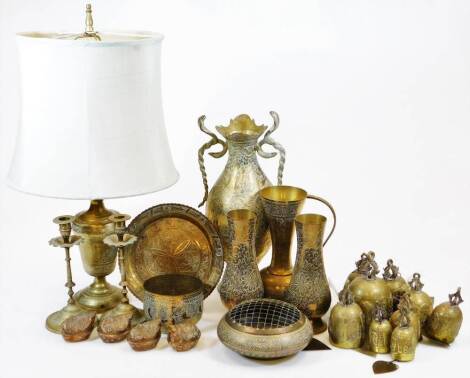 Various eastern metalware, early 20thC brass ware, rope twist vase of baluster form terminating in circular foot, 34cm high, pair of vases, lamp, hand bells, ewer, compressed rose bowl, etc. (a quantity)