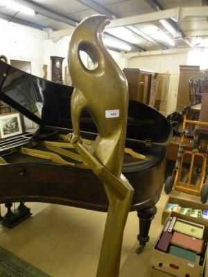 A modern gilt sculpture of a bird on a pedestal by Leonard Stephens