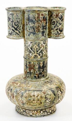 A Chinese bronze arrow vase, decorated in Shang style inlaid in silver with archaic designs, masks and hieroglyphs, 30cm high.