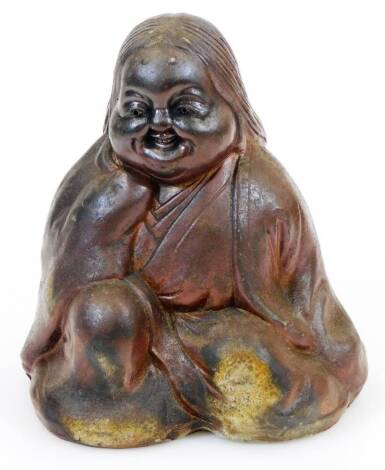 A Japanese Bizen figure of Okame, smiling blissfully as she pleasures herself, Meiji period, 15.5cm high.