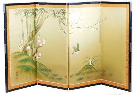 A 20thC four fold table Japanese screen, decorated with birds among prunus and bamboo, signed, with a black lacquered frame, 62cm high.