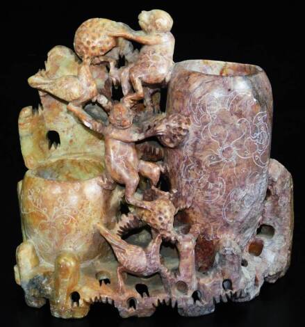 A carved Chinese soapstone figure group of monkeys and birds, with double vase opening on a shaped pierced base, 23cm high.